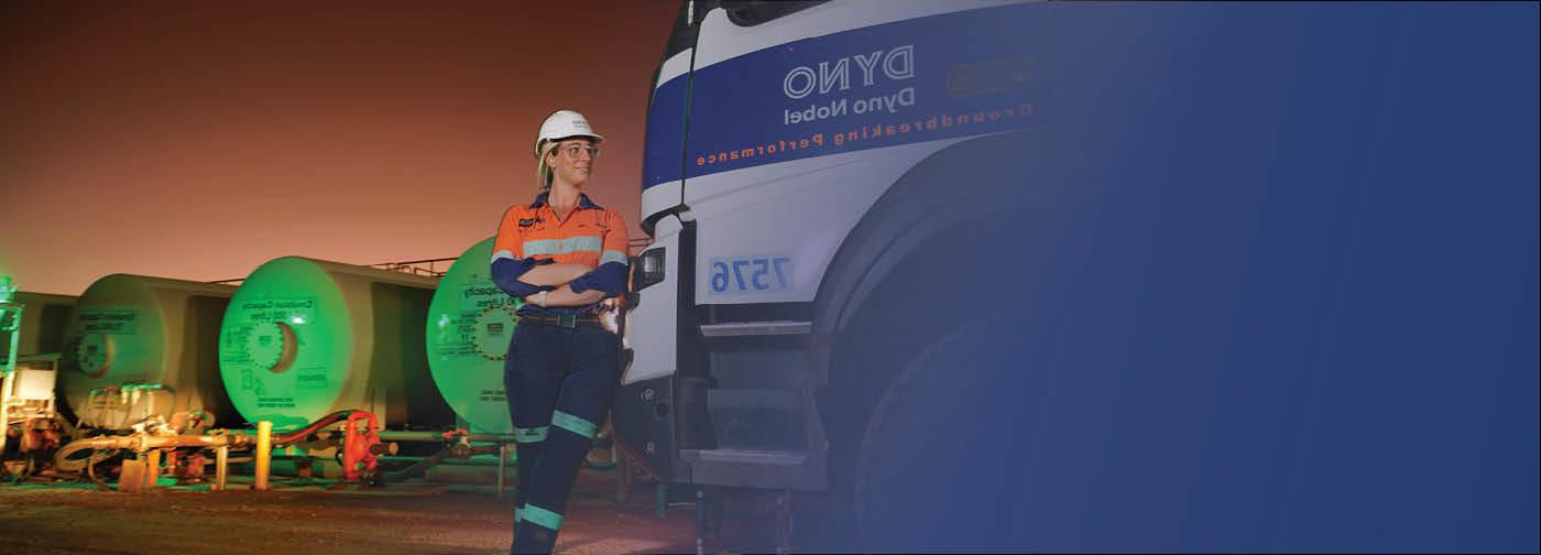 Image of female worker next to truck.